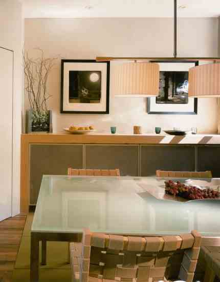 The dining room got a facelift, including a built-in buffet of sustainably forested maple with perforated metal doors. The carpet squares are FLOR, from Interface, made with recycled PET bottles.